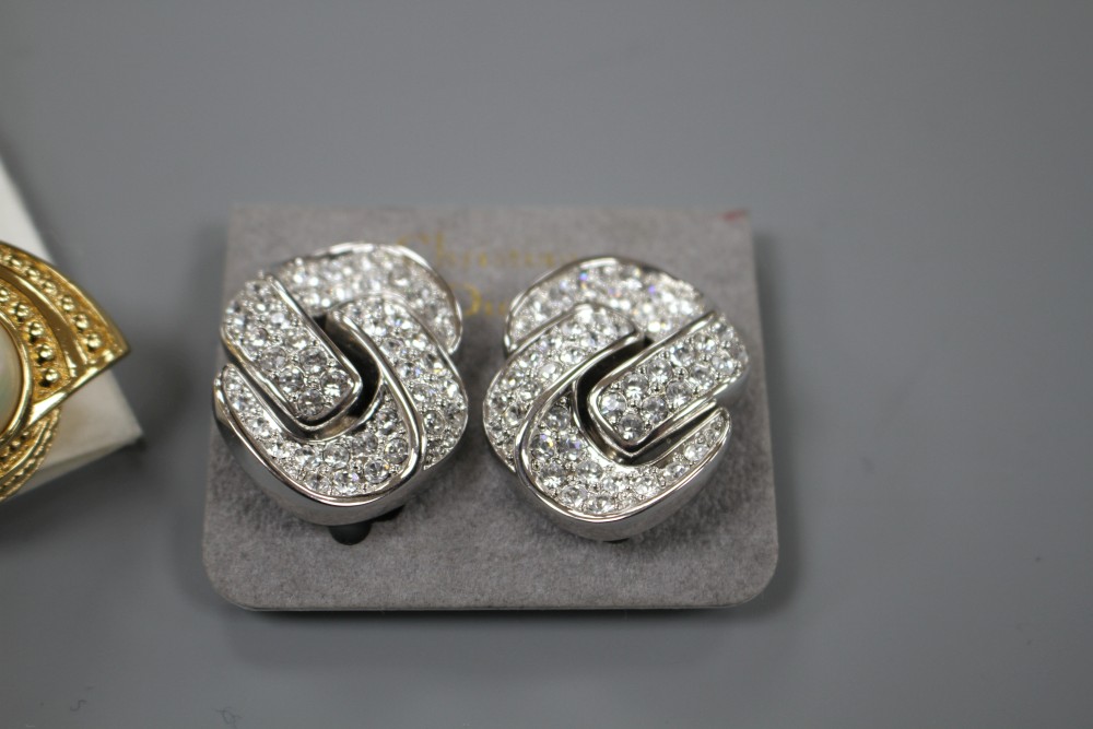 Two pairs of Christian Dior costume ear clips, white paste and simulated pearl, both approx. 33mm, both in Dior boxes.